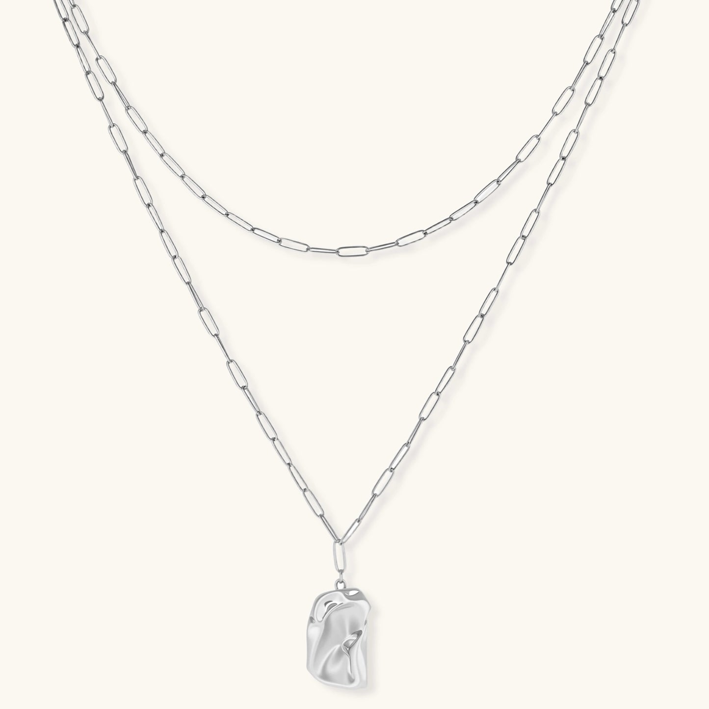 Layered paperclip chain necklace with organic flowing pendant made from eco-zinc alloy in warm gold finish