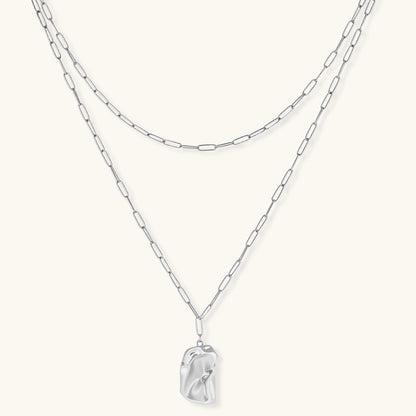Layered paperclip chain necklace with organic flowing pendant made from eco-zinc alloy in warm gold finish